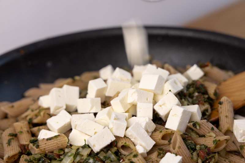 Adding feta cubes to pasta