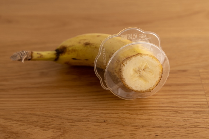 Banana half wrapped using a silicone food saver