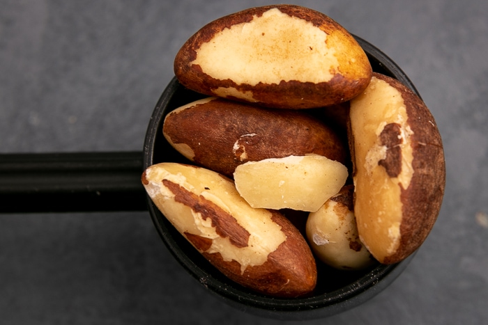 Brazil nuts in a black scoop