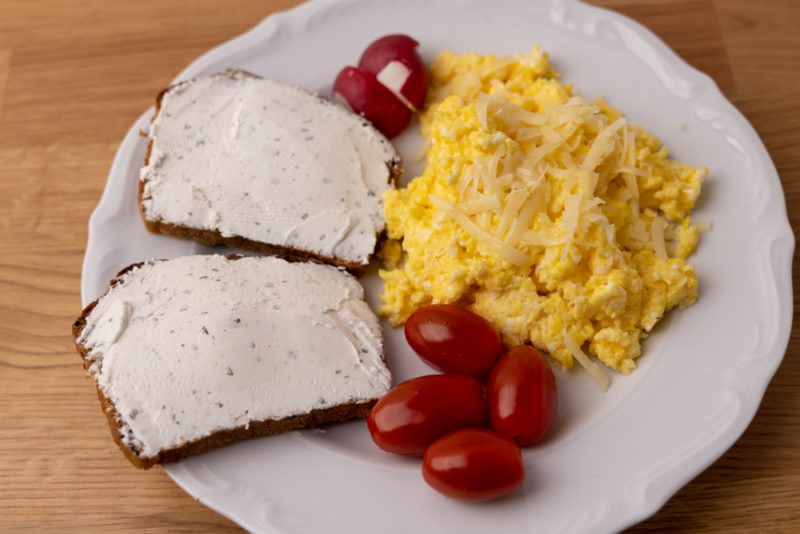 Bread with goat cheese and scrambled eggs