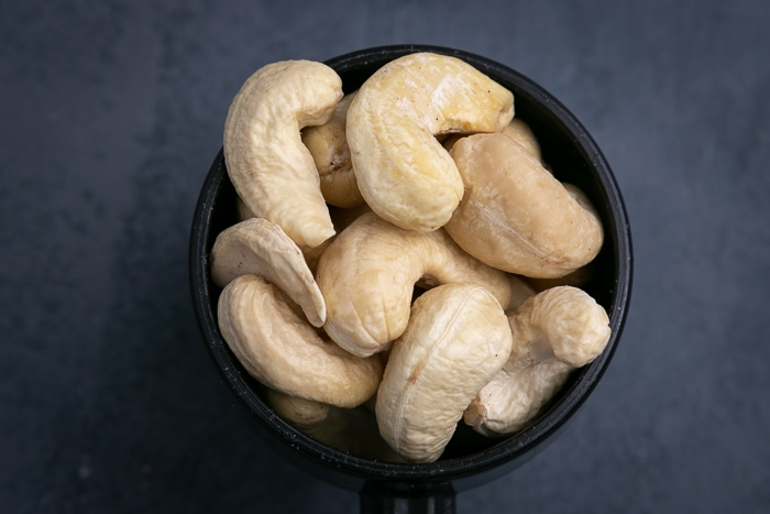 Cashews in a black scoop