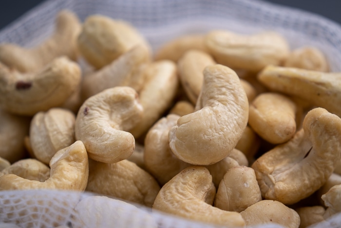 Cashews in a mesh bag closeup