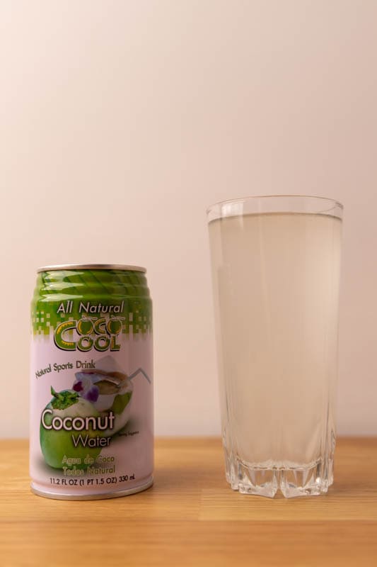 Coconut water: can and glass with liquid