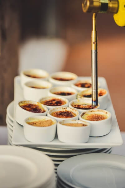 Creme brulee in small bowls on a tray