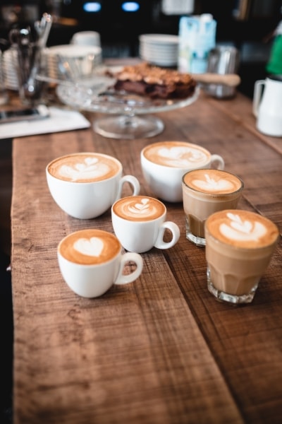 Cups of coffee with decorations on top