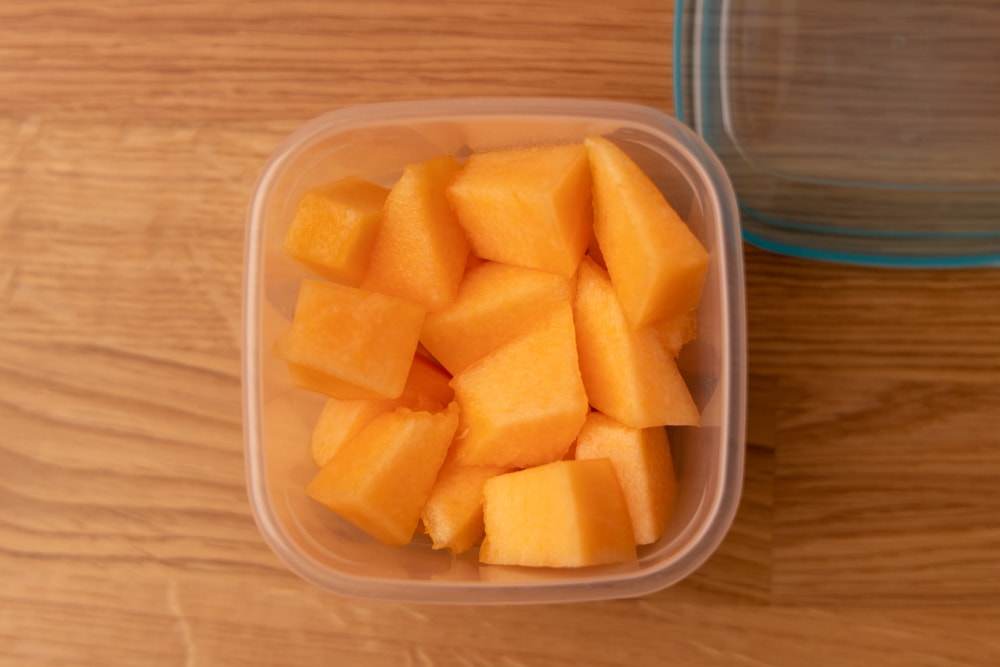 Diced cantaloupe in a plastic container