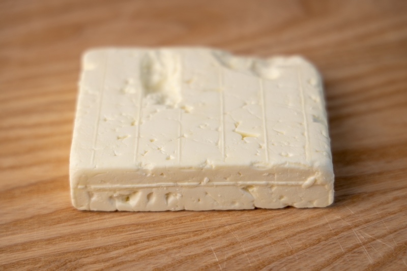 Feta cheese block on a cutting board