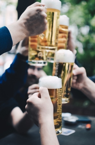 Five beer mugs filled with beer