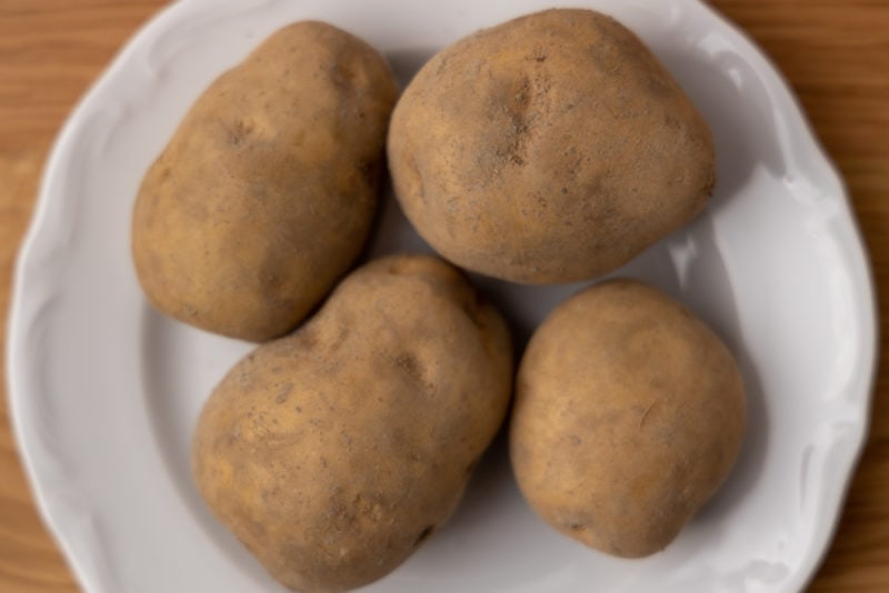 Four unpeeled potatoes