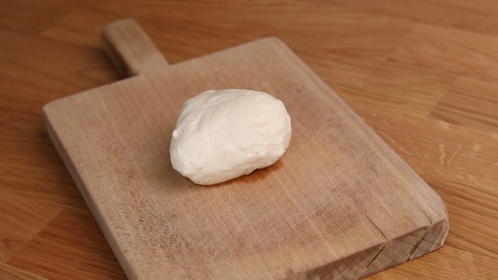 Fresh ball of mozzarella on a cutting board
