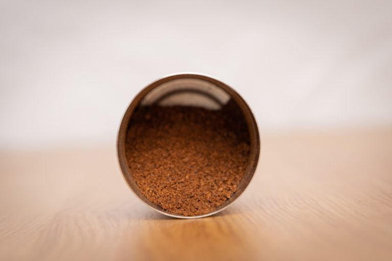 Freshly ground coffee in a grinder