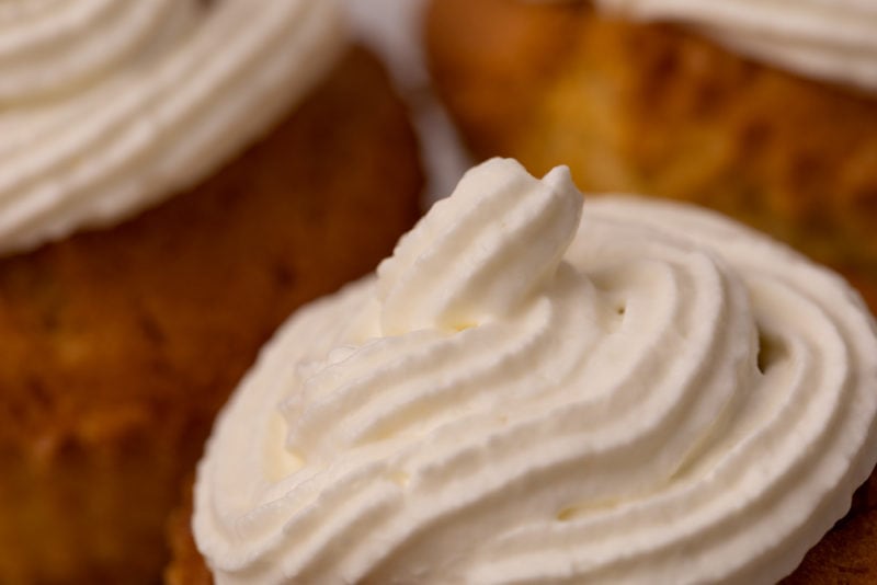 Frosted cupcakes with whipped cream