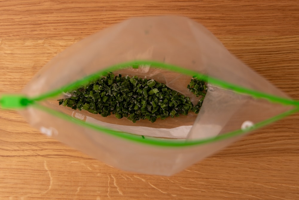 Frozen chives in a freezer bag