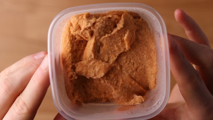 Frozen hummus in freezer container