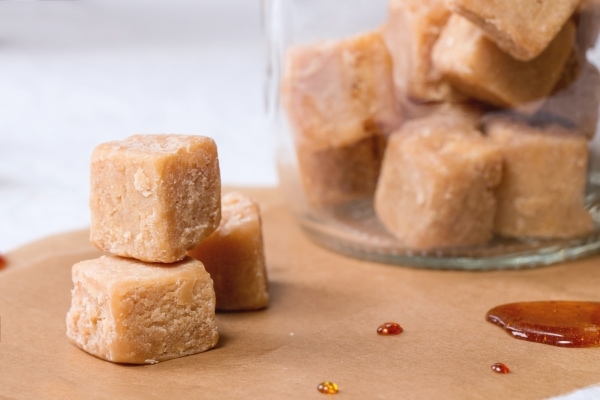 Fudge candy on baking paper and in glass jar