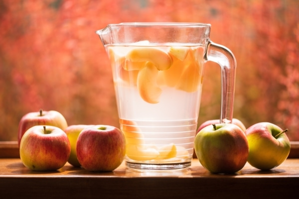 Glass pitcher and apples