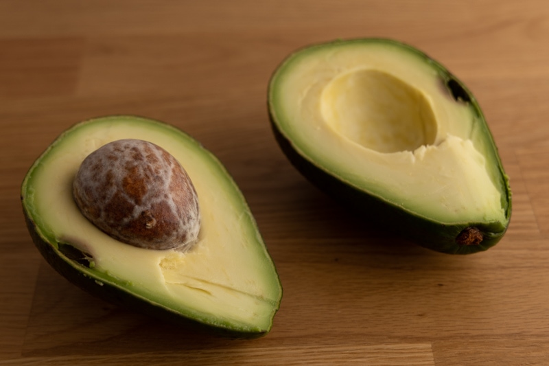 Halved avocado with a spoiled spot