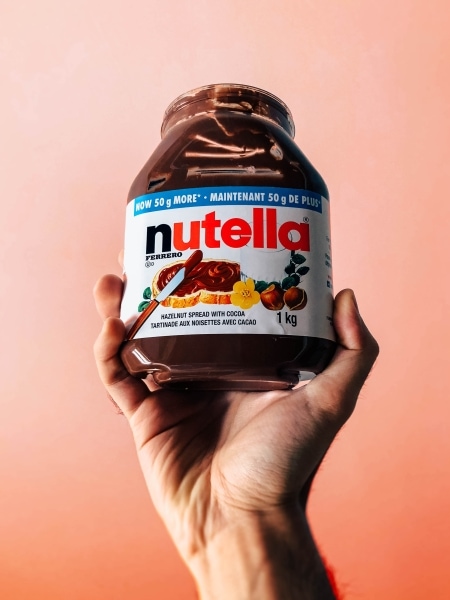 Person holding a jar of Nutella