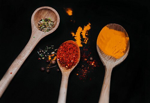 Various spices on wooden spoon