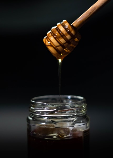 Honey dripping from a honey dipper