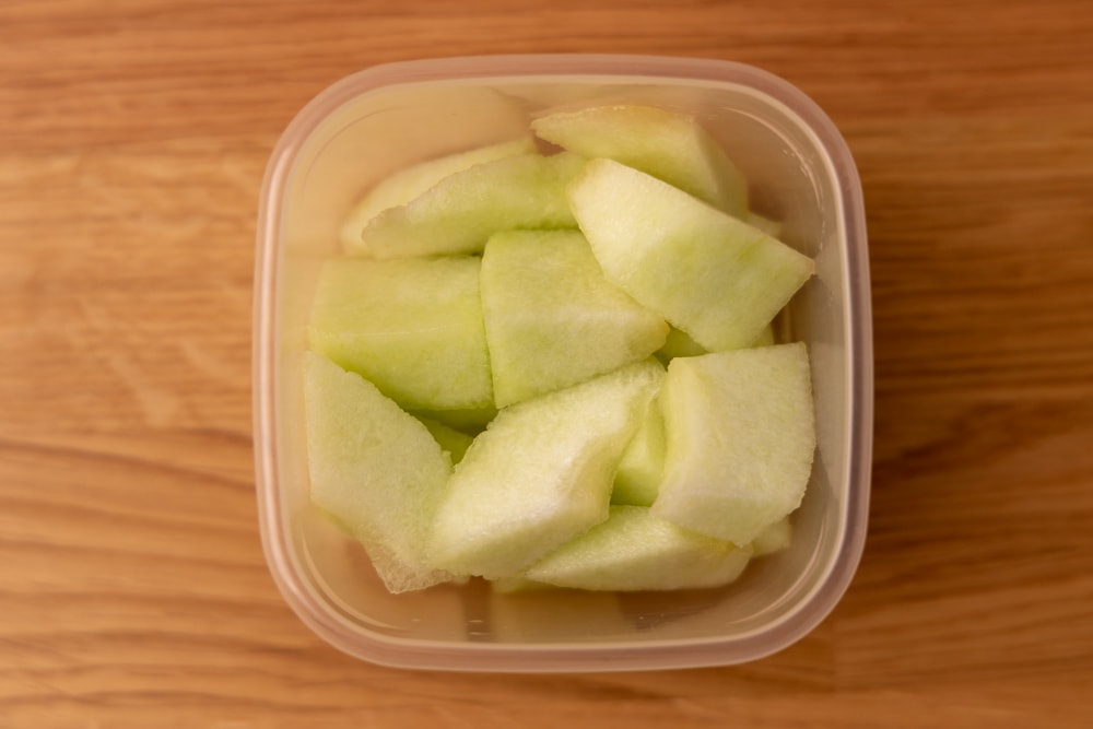 Honeydew cubes in a container