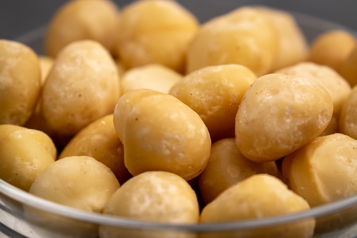 Macadamia nuts in a glass bowl closeup