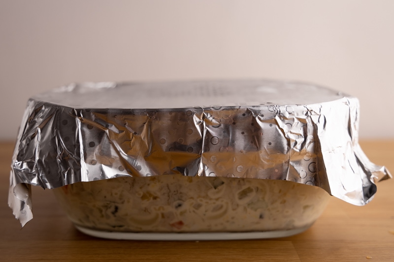 Macaroni salad bowl wrapped with aluminum foil