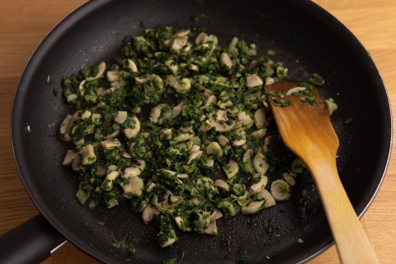 Sauteeing mushrooms with spinach