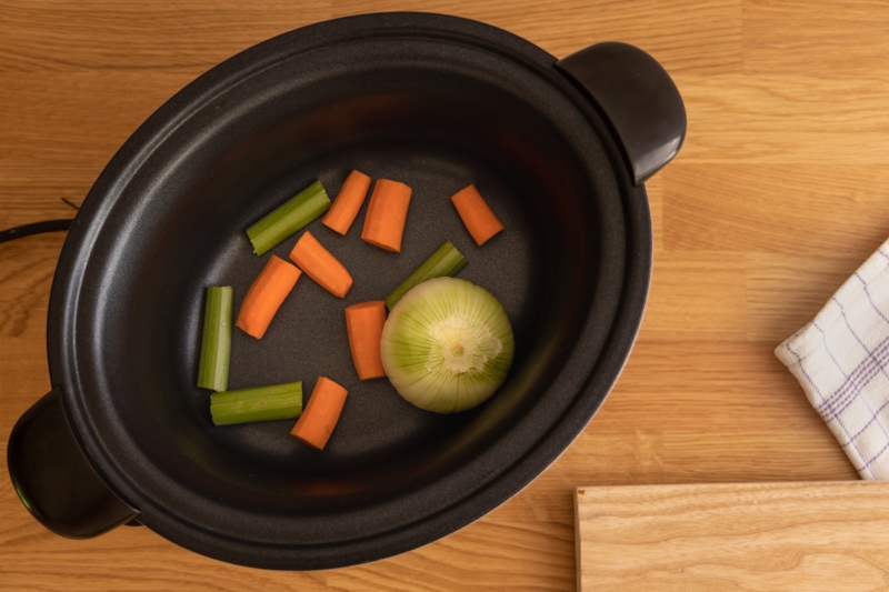 Making broth: an onion and a carrot