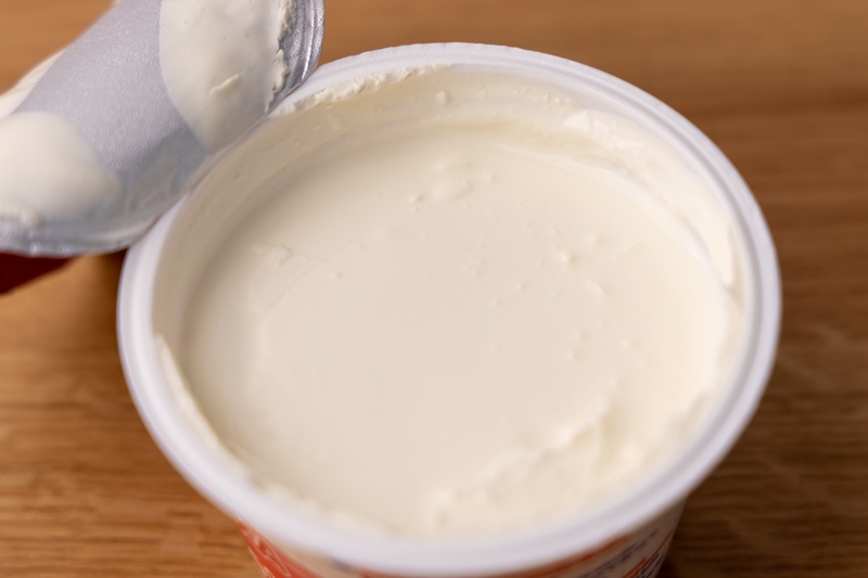 Opened container of thick heavy cream