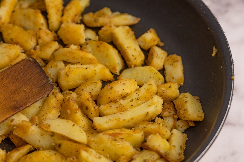 Parcooked potatoes cooked in a skillet