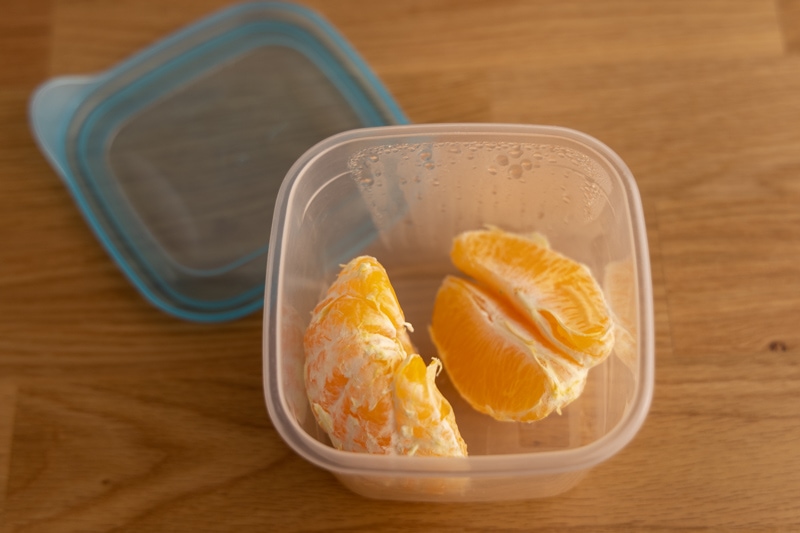 Peeled orange segments in an airtight container