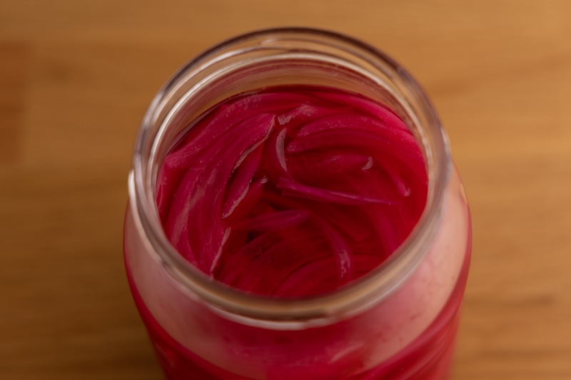 Pickled onions submerged in pickling liquid
