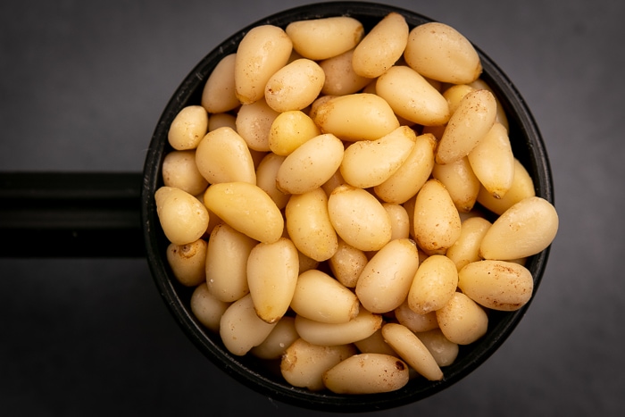 Pine nuts in a black scoop