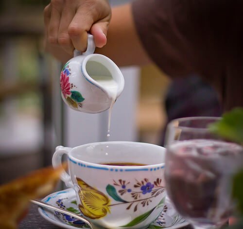 Pouring milk in coffee