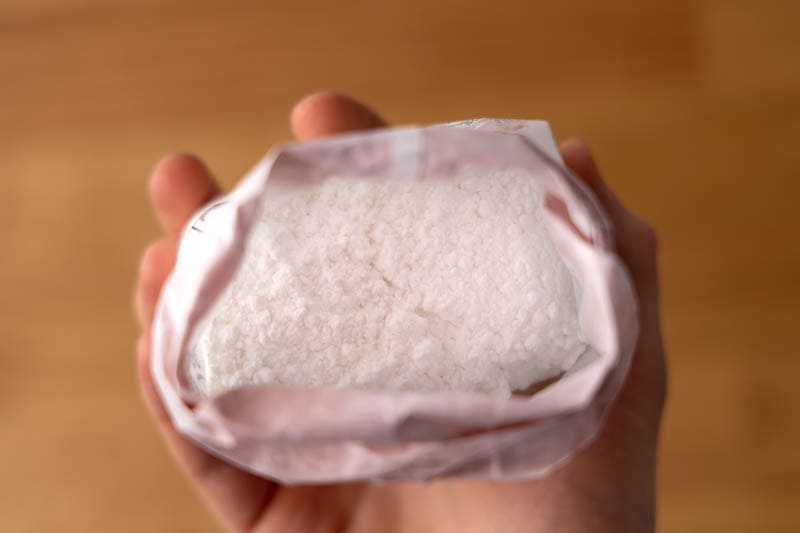 Powdered sugar bag in hand