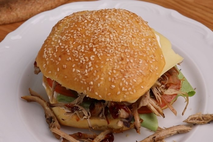 Prepared burger with thawed and reheated pulled pork