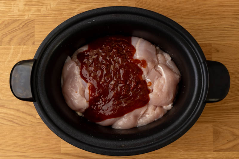 Prepping chicken with barbecue sauce