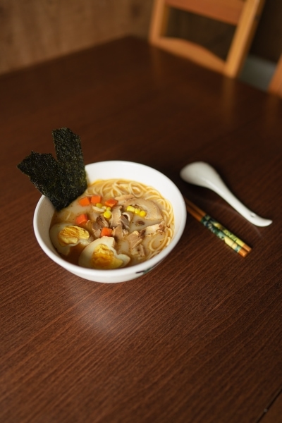 Bowl of ramen noodles with egg and seaweed