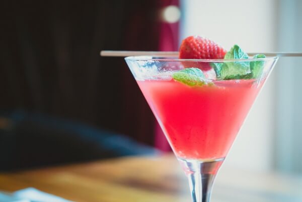Red cocktail with strawberry on top