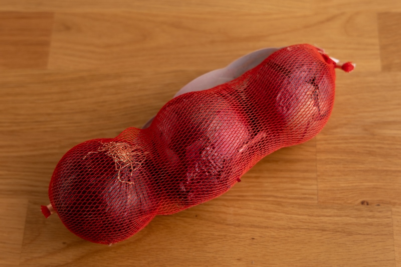 Red onions in a mesh bag