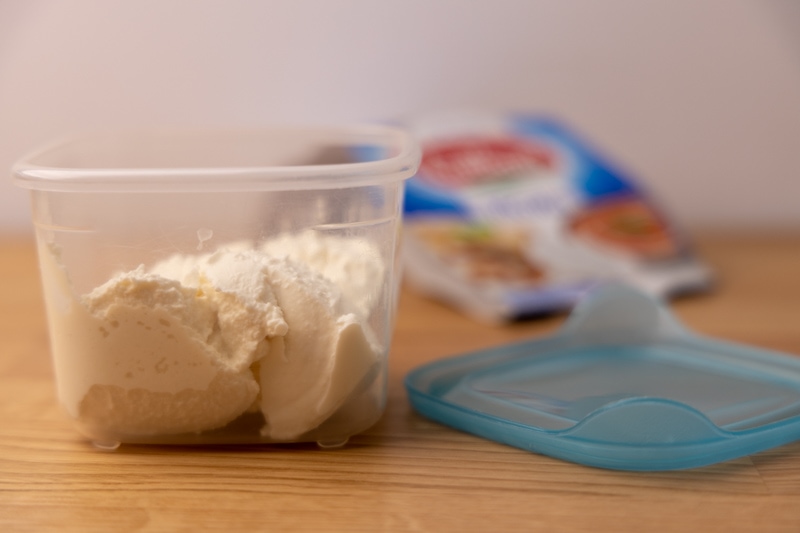 Ricotta in a plastic container