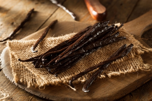 Raw vanilla beans on a cutting board