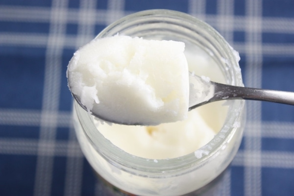 Scooping coconut oil from a jar)