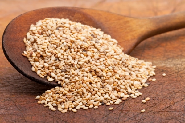 Sesame seeds on a wooden spoon