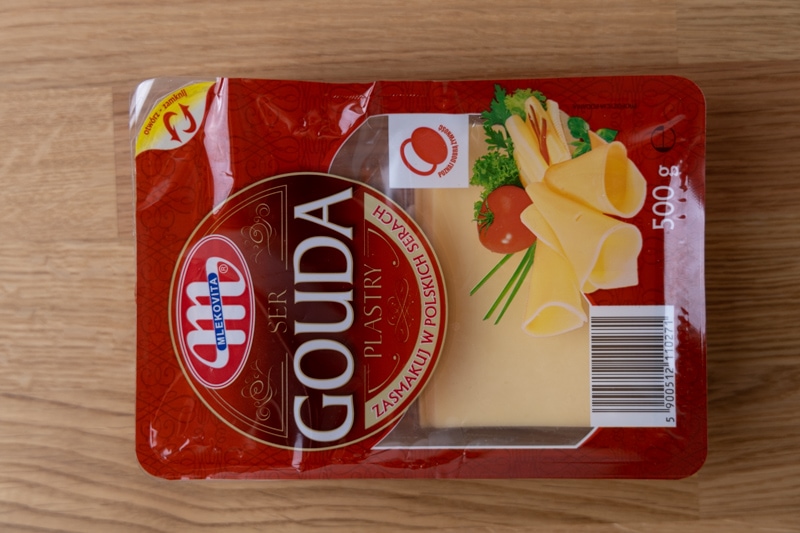 Sliced gouda cheese in a resealable container