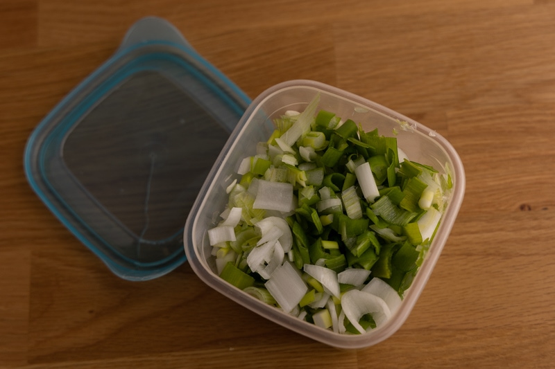 Sliced green onions in an airtight container