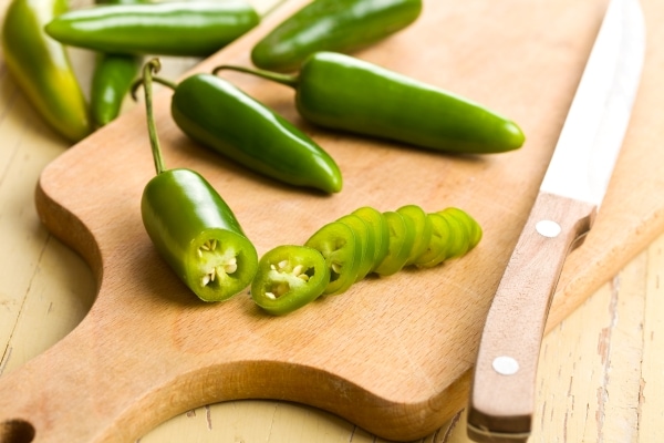 Jalapenos sliced on a cutting board