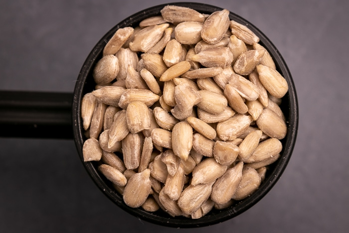 Sunflower seeds in a black scoop