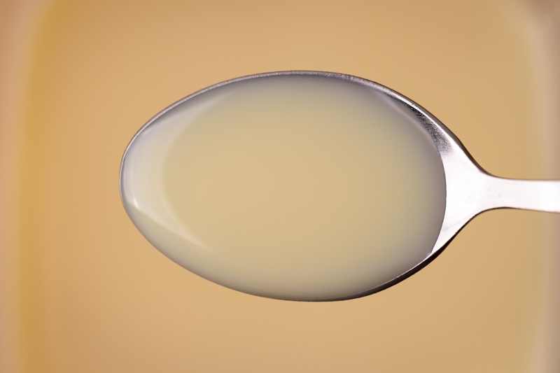 Thawed condensed milk on a spoon